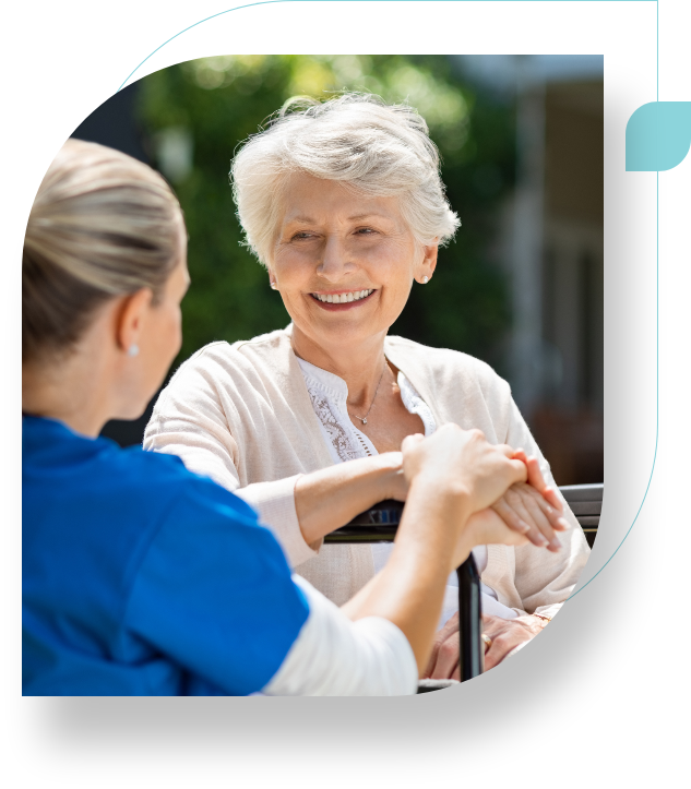 A woman and a nurse are holding hands.