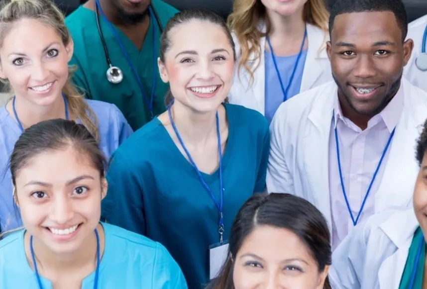 A group of doctors and nurses are smiling for the camera for home health care services